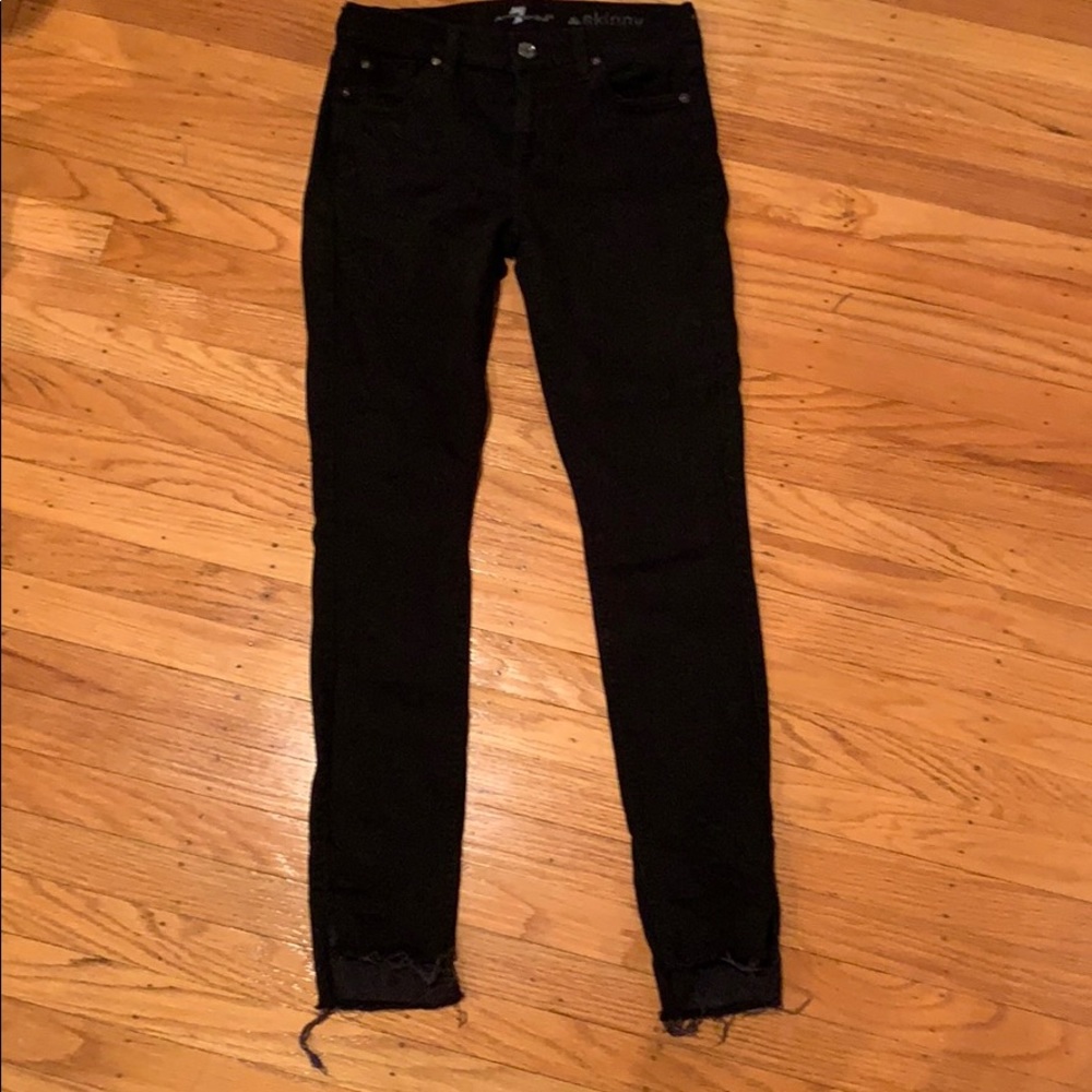Black high-waisted skinny jeans with frayed hem